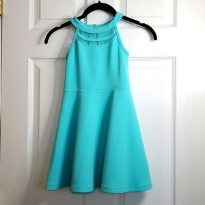 Fancy Girls Teal dress with mesh covered cut outs.